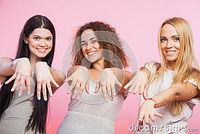 Three pretty women show hands fingers and nails. Stock Photo