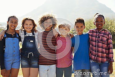 Three quarter length portrait of pre-teen friends in a park Stock Photo