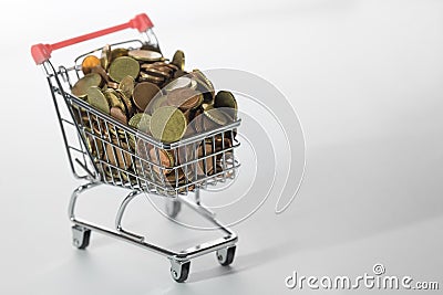 Mini Chrome Shopping Cart Filled To the Top With Coins Stock Photo