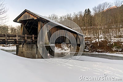 A three-quarter view of the snow covered Livingston Manor Covered Bridge Editorial Stock Photo