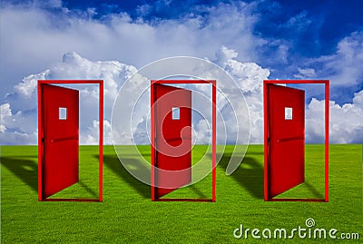 Three Red door placed on an outdoor lawn with blue sky floor Stock Photo