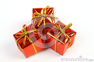 Three red glossy gift boxes with gold bow on white background Stock Photo