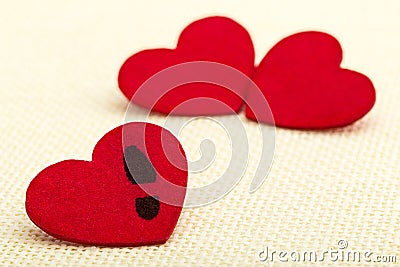Three red hearts. Concept of broken heart and infidelity Stock Photo