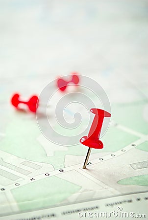 Three Red Marking Pins on Top of a Map Stock Photo