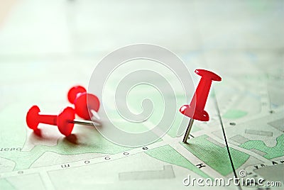 Three Red Marking Pins on Top of a Map Stock Photo