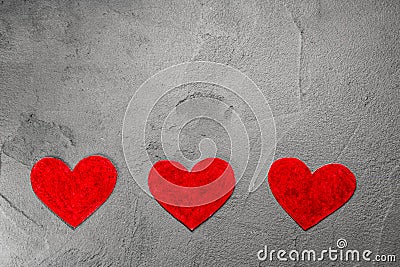Three Red paper hearts on gray wall with copy space Stock Photo