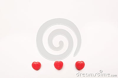 Three Red Valentine`s day heart shape candy line on white paper background. Love Concept. Minimalism style. Knolling top view. Stock Photo