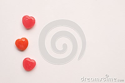 Three Red Valentine`s day heart shape candy line on white paper background. Love Concept. Minimalism style. Knolling top view. Stock Photo