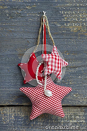 Three red white checkered handmade christmas stars hanging on a Stock Photo