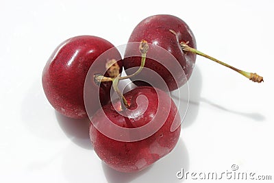 Three ripe juicy red sweet cherries on a white background Stock Photo