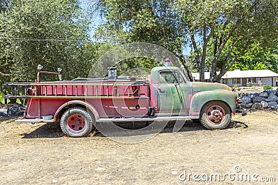 Old vintage dirty fire engine vintage car at an outdoor loam parking lot in three rivers Editorial Stock Photo