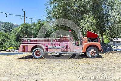 Old vintage dirty fire engine vintage car at an outdoor loam parking lot in three rivers Editorial Stock Photo