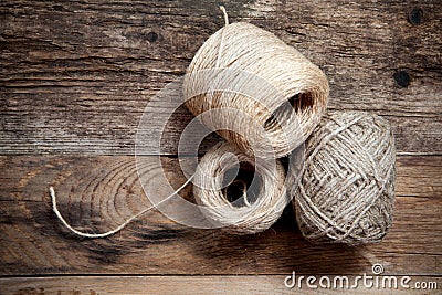 Three rope coils on old wooden background Stock Photo