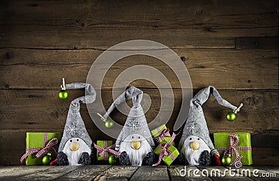 Three santa with red felt hats and apple green christmas present Stock Photo