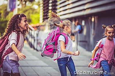 Cheerfully day. Three school girls outside Stock Photo