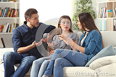 Three serious friends talking sitting on a couch at home Stock Photo