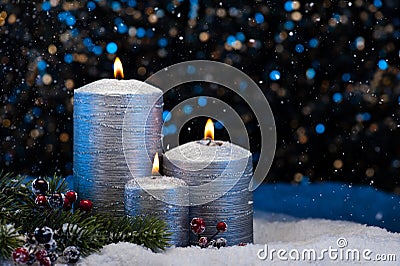 Three Silver Candles in snow Stock Photo