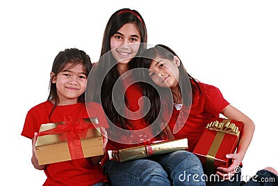 Three sisters holding presents Stock Photo