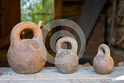Three small calibration weights standing on wooden background Stock Photo
