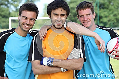 Three smiling footballers Stock Photo