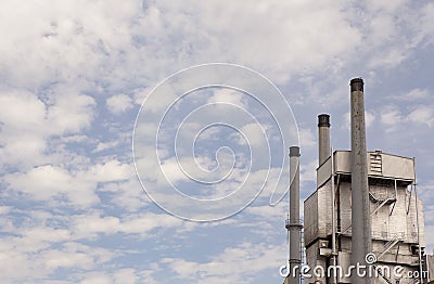 Three Smoke stacks on power plant Stock Photo