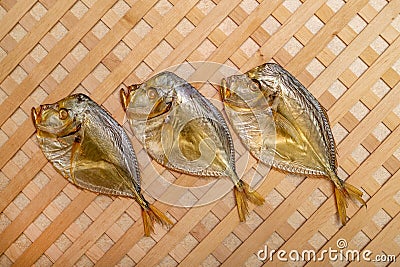 Three smoked sea fish Selene close-up on a string Stock Photo