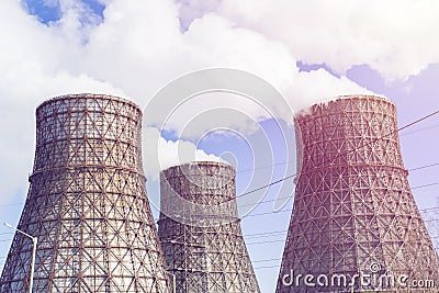 Three soaring evaporators of CHP against the background of blue sky. Stock Photo