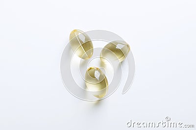 Three soft gel capsules, transparent softgels, from above Stock Photo