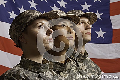 Three soldiers posed in front of American flag, horizontal Stock Photo