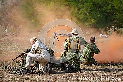 Three Soviet soldiers is beating off the attack of the mujahideen using a smoke screen Editorial Stock Photo
