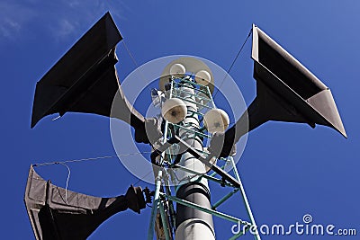 Three speakers hoisted into a light tower Stock Photo