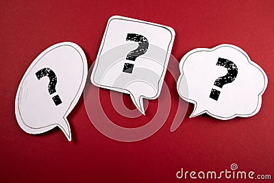 Three speech bubbles with question marks on a red background Stock Photo