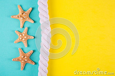 Three starfishes and sea rope on colored backgrounds with negative space Stock Photo