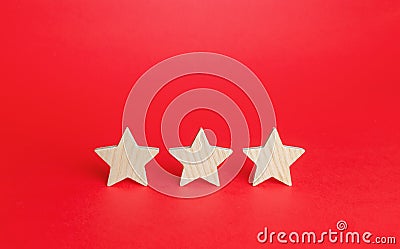 Three stars on a red background. Rating evaluation concept. Service quality. Buyer feedback. High satisfaction. Good reputation Stock Photo