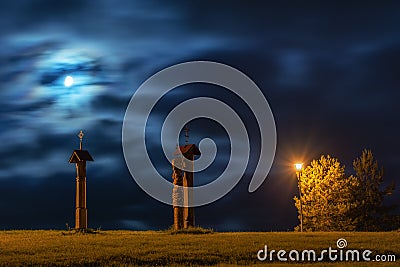 Three statues in field at night Stock Photo