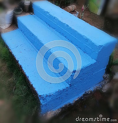 Three steps Blue painted stairs with bermuda grass around Stock Photo