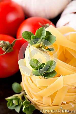 Three stigs of oregano on portion of fettuccine pasta Stock Photo