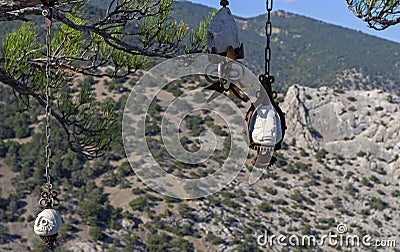 Three stone idol on the branches of pine tree in the Crimean mountains. Stock Photo