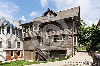 Three-storey beautiful expensive house with a triangular roof surrounded by green lawn Editorial Stock Photo