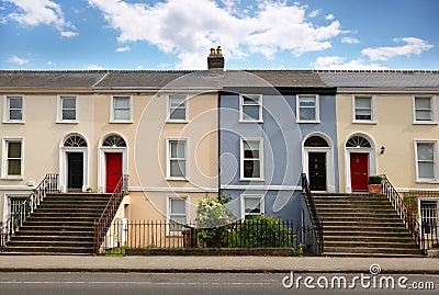 Three-story house stands beside road Stock Photo