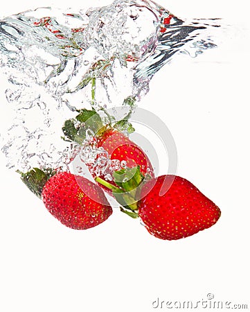 Three strawberries falling Stock Photo