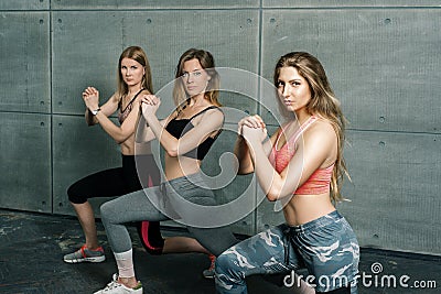 Three strong slender sports girls train fitness aerobics Stock Photo