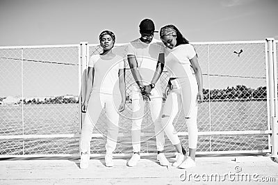 Three stylish african american friends, wear on white Stock Photo