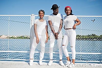 Three stylish african american friends, wear on white Stock Photo