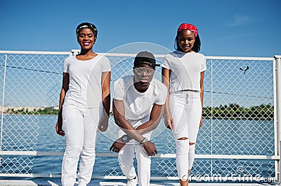 Three stylish african american friends, wear on white Stock Photo