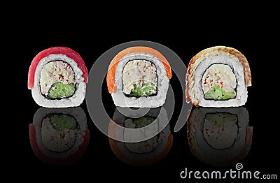 Three sushi rolls with salmon, tuna and eel on black background Stock Photo