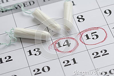 Three tampons on the menstruation calendar Stock Photo