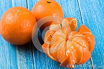 Three tangerine on a blue wooden background Stock Photo