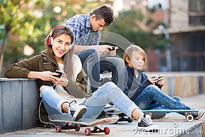Three teenagers with smartphones Stock Photo