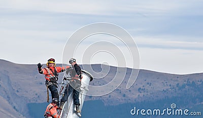 Three thumping assemblers under the helicopter Editorial Stock Photo